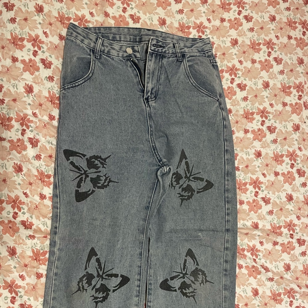 High rise wide leg denim jeans with black butterfly decals